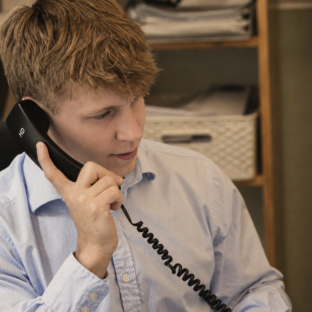 Digby Associates team member speaking with a client by telephone.